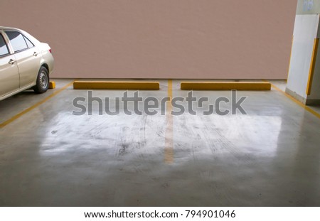 empty parking car with brown concrete wall