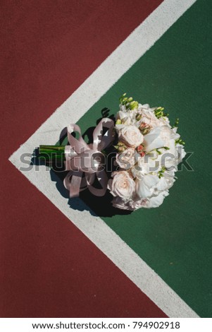 luxurious bridal bouquet of white peonies and roses on a cort