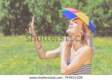 LGBT discrimination - girl posing with a multicolored umbrella in nature.