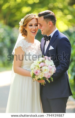 Wedding: beautiful bride and groom in the park on a sunny day