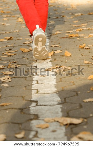 the child walks along on road. walk in autumn. feet