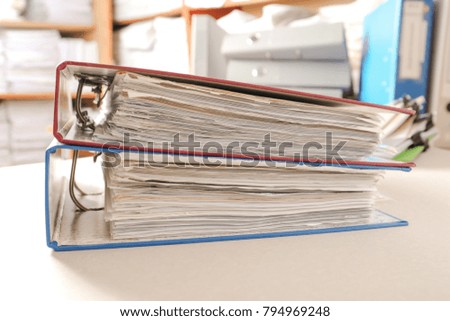 Folders with documents on table in archive