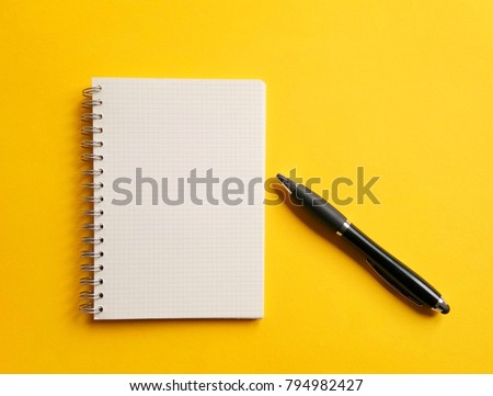 notebook,pen, on yellow background. top view copy space  Royalty-Free Stock Photo #794982427
