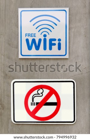 Free WiFi and no smoking sign on concrete wall.