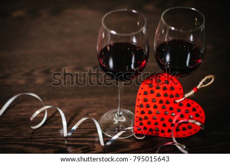 Concept Women's Day, eighth of March. A romantic love concept holiday, ribbons, wine, red hearts on brown wooden background. Place for text. Wedding, jubilee. St. Valentine's Day.