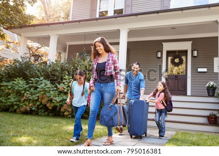 Family With Luggage Leaving House For Vacation Royalty-Free Stock Photo #795016381