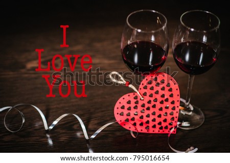 Text I love you. A romantic love concept holiday, ribbons, glasses of wine, red hearts on brown wooden background. Women's Day, eighth of March. Wedding. St. Valentine's Day.