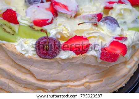 Homemade Pavlova cake with fresh strawberries, cherry  and kiwi ready to serve