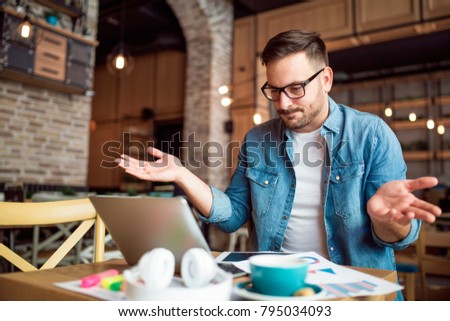 Modern young man having no idea what to do Royalty-Free Stock Photo #795034093