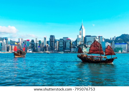 Hong Kong cityscape and skyline, Tourist junk boat at Victoria Harbor, Beautiful view of the Hong Kong Island.