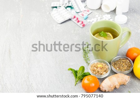 Alternative remedies and traditional pills to treat colds and flu. Natural medicine vs conventional medicine concept. Copy space. Royalty-Free Stock Photo #795077140