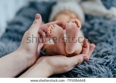 Parent holding newborn baby feet. Mom and her Child. Happy Family concept. Beautiful conceptual image of Maternity Royalty-Free Stock Photo #795086668