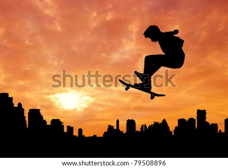 youth male skateboarder jumping over the city during sunset silhouetted