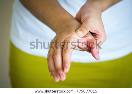 Closeup of young woman suffering from pain in hand, People with body-muscles problem, Healthcare And Medicine concept
