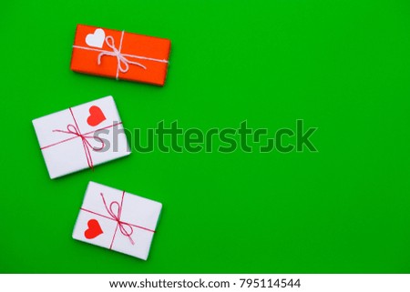 Love gift boxes on green background with hearts. Greeting gift. Love concept