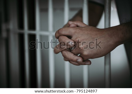 Hands of men desperate to catch the iron prison,prisoner concept,thailand people,Hope to be free. Royalty-Free Stock Photo #795124897