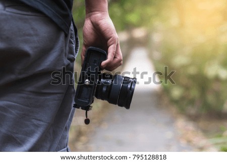 male photographer, hand hold camera, outdoor