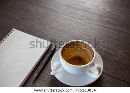 Blank notebook on the coffee table, latte art 