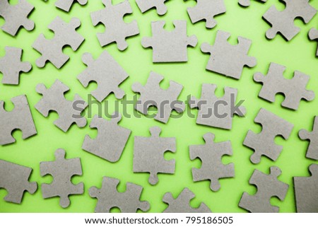 Find solution, jigsaw puzzle parts on green background