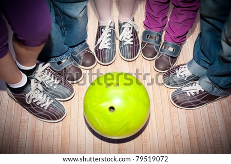 children's feet in shoes and a bowling ball for the game