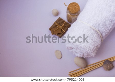 spa setting with sea salt, towel and massage product