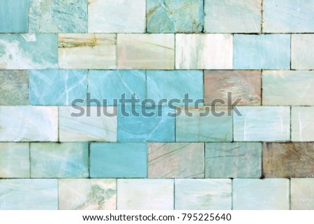 Background of bright tiles.Wall of marble. Unusual stone texture.