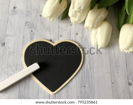 st valentines day chalkboard. st valentines day tulips with heart shaped chalkboard for your text and logo on white wooden background. 