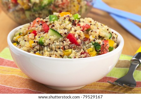 Delicious vegetarian quinoa salad with bell pepper, cucumber and tomatoes (Selective Focus, Focus one third into the bowl) Royalty-Free Stock Photo #79529167