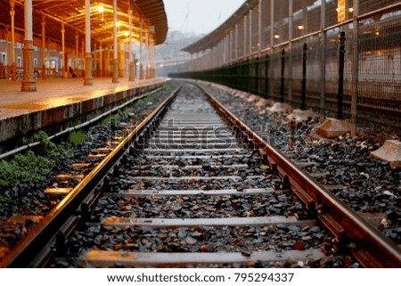 Photo from a train station's rail track when it is empty.