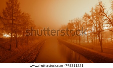 Orange mist at canal at night