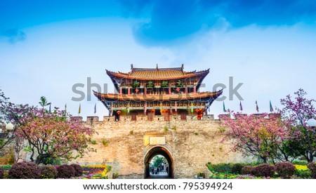 Traditional Chinese building. South Gate of Dali Old Town. Text on the pavilion translating into English is famous town of culture. Located in Dali, Yunnan, China