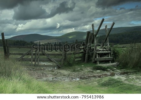 Beautiful rural landscape. Wooden fence on the background of mountains. Glen Dye, Scotland, United Kingdom.