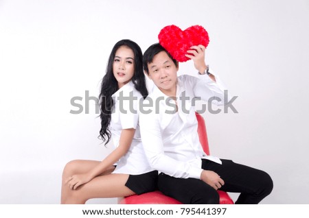 The couple in love , show heart pillow and gift on isolate white background
