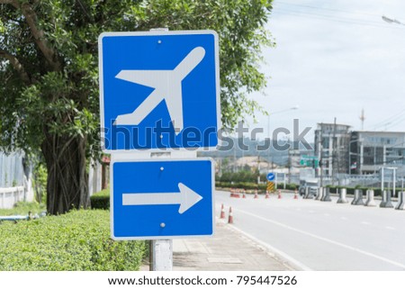 Airport sign with airplane symbol and arrow pointing right on th