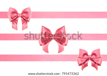 two Decorative silk pink ribbon bows with ribbons in different sizes over white background