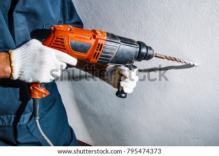 man with electric drill Royalty-Free Stock Photo #795474373