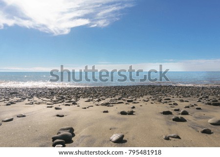 The beach has lots of rocks with the background image of the sky on sunny days at the New Plymouth City. Country New Zealand