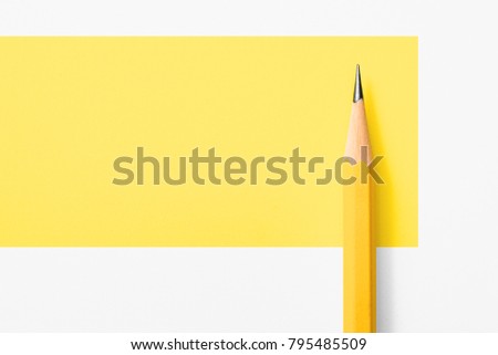 Minimalist template with copy space by top view close up macro photo of wooden yellow pencil isolated on white texture paper and combine with yellow graphic.Flash light made smooth shadow from pencil. Royalty-Free Stock Photo #795485509