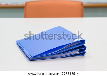 Blue File folder with Documents on white table in meeting room - concept business