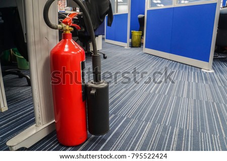red fire extinguisher in office for safety