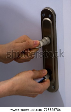 Woman locking the entrance door of the her house