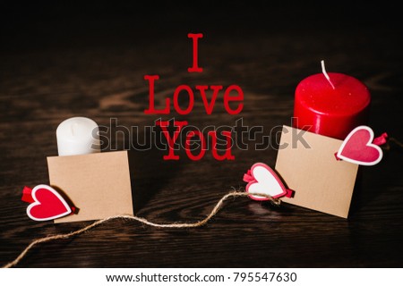 Text I love you. Blank, craft paper with clothespins, candle, red heart, rope on brown wooden background with space. Place for text. concept Women's Day, eighth of March. Wedding, jubilee.