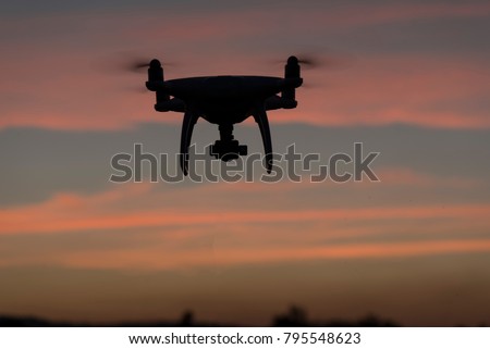 Flying drone above the professional camera takes pictures of the Sky