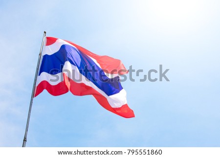 Thailand national flag waving with blue sky in background