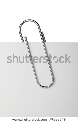 close up of  a metal paper clip and paper on white background Royalty-Free Stock Photo #79555849
