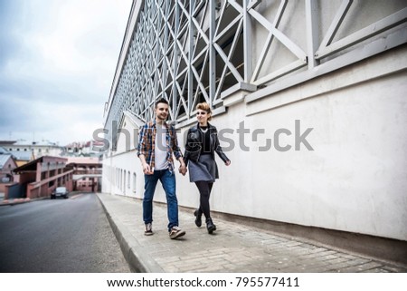 couple in love walking down the street of a modern city.