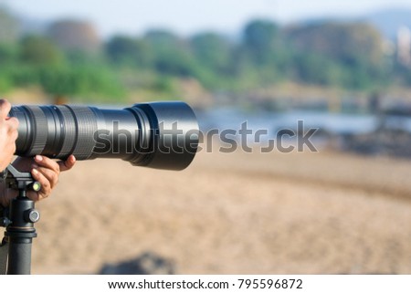 Telephoto lens - photographer zooming the lens 