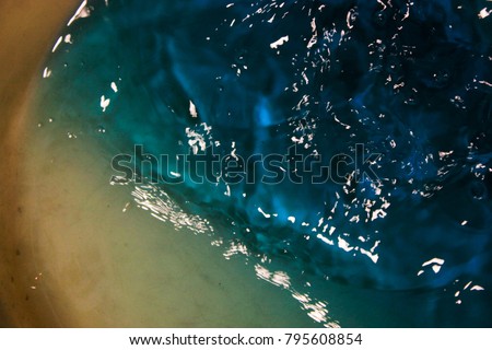 Blue turquoise defocused water topview. bubbles and waves in motion. Pure Sea, ocean.Abstract, surrealism pattern, texture. Lines and forms of liquid. It's bright and calm. Relax. Peace.