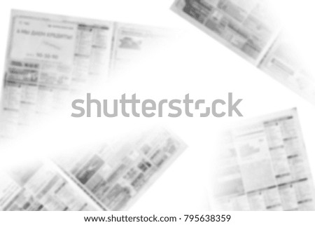Lots of old newspapers on horizontal surface. Pages with articles, headlines and photos. Daily papers with business news. Background texture, top view, blurred