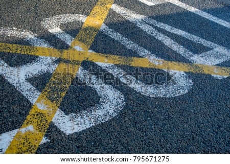yellow criss cross box on the road 